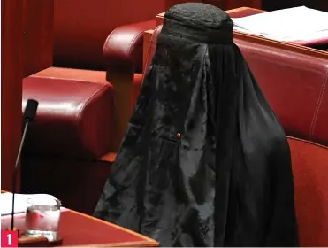  ??  ?? Guess who: Senator Pauline Hanson takes her seat concealed in a burka 1