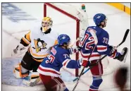  ?? (AP/Frank Franklin II) ?? New York’s Filip Chytil (72) celebrates Wednesday as he skates by Pittsburgh goalie Louis Comingue after scoring the tie-breaking goal early in the third period of the Rangers’ 5-3 victory over the Penguins in New York.