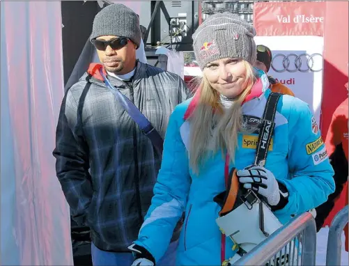  ?? ROBERT PRATTA / REUTERS ?? Lindsey Vonn of the US and her boyfriend, golfer Tiger Woods, leave after the women’s World Cup Downhill skiing race in Val d’Isere, the French Alps, on Saturday. Vonn failed to put together a winning run for Woods as her unstable right knee gave way...