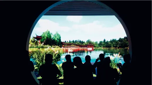  ?? ?? Tourists enjoy a digital presentati­on of the West Lake landscape using advanced technology at the West Lake Museum in Hangzhou, Zhejiang Province, on 2 October