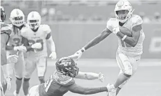  ?? JOHN MCCALL/SOUTH FLORIDA SUN SENTINEL ?? Dolphins receiver Preston Williams breaks a tackle from Jets linebacker Brandon Copeland on Nov. 3, 2019.