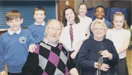  ??  ?? Ron and Pat Forsyth with pupils who took part in the dementia café launch.