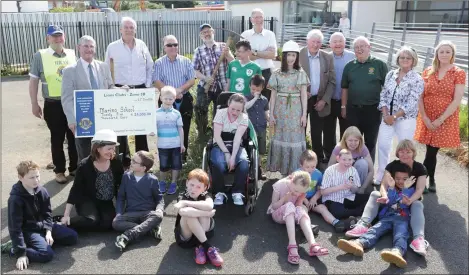  ??  ?? Lions Club members hand over a cheque to Marino Community Special School.