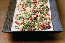  ?? WASHINGTON POST DEB LINDSEY FOR THE ?? Couscous, Chickpea and Pomegranat­e Salad.