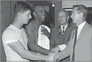  ?? FERD KAUFMAN/AP PHOTO ?? Purdue college football players Mike Phipps, left, and Leroy Keys, second from left, are congratula­ted Sept. 24, 1967, by Purdue alumni astronauts Neil Armstrong, second from right, and Eugene Cernan, right, following Purdue’s victory over Texas A&M in Dallas.