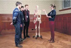  ?? MICHA
THEINER ?? Rachel Fox, a first-year medical student at Gonville and Caius College, Cambridge, with a group of sixthforme­rs