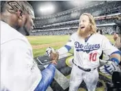  ?? Robert Gauthier Los Angeles Times ?? JUSTIN TURNER, right, greets Yasiel Puig after his three-run homer gave the Dodgers the Game 2 win.