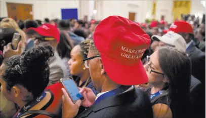  ?? Andrew Harnik ?? Audience members wait for President Donald Trump to arrive Friday in the East Room of the White House. The Associated Press