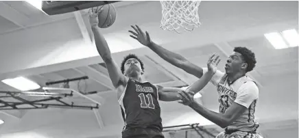  ?? CATALINA FRAGOSO-USA TODAY SPORTS ?? IMG Academy Ascenders forward Jaden Springer (11) drives the ball to the hoop past Montverde Academy Eagles forward Omar Payne (13) during a high school basketball game in April 2019.