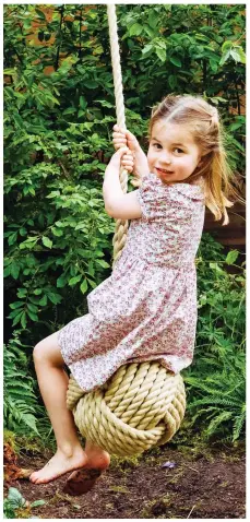  ??  ?? Swing time: Happy Charlotte gets her feet muddy