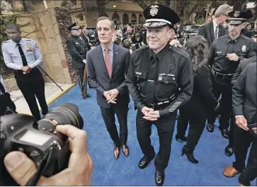  ?? Al Seib Los Angeles Times ?? MAYOR ERIC GARCETTI, left, at Michel Moore’s swearing-in. Moore came out of the Deferred Retirement Option Plan with a $1.27-million windfall, but didn’t retire after five years. Instead, he became LAPD chief.