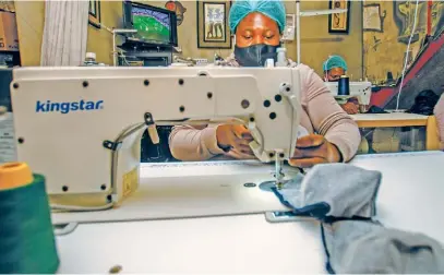  ?? Picture: Supplied ?? BUSINESS IS BOOMING. Hluvuko Designs director Ponani Shikweni sews masks at her small business in Alexandra.
