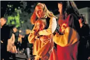  ?? ?? Parents and children at a vigil outside the Belgrade school where eight pupils and a security guard were killed