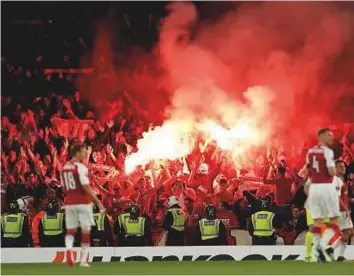  ?? Reuters ?? FC Koln fans celebrate their first goal against Arsenal by letting off flares in the Emirates Stadium in London on Thursday.