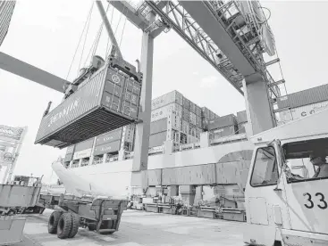  ?? Stephan Savoia / Associated Press file ?? A container ship from China is offloaded in 2012 in Boston. President Donald Trump signed two executive orders Friday focused on reducing the trade deficit just days before he meets his Chinese counterpar­t.