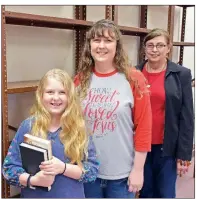  ?? STACI VANDAGRIFF/THREE RIVERS EDITION ?? Gwen Goodwin, from left, and her mother, Trish, and former Cushman Schools librarian Becky Wood, stands inside what will be the new community library at the former Cushman school building. Gwen, a fifth-grader at Eagle Mountain Elementary School in Batesville, raised more than $300 to help kick-start the library.