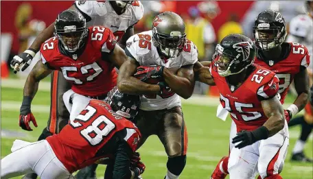  ?? CURTIS COMPTON / CCOMPTON@AJC.COM ?? Mike James (trying to run through the Falcons defense when he played for the Bucs in 2013) is a free agent.