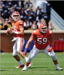  ?? AP file- Richard Shiro ?? Clemson quarterbac­k Trevor Lawrence drops back to pass with blocking help from Gage Cervenka during the first half of l game against Georgia Southern in Clemson, S.C. The Tigers remain committed to playing both incumbent starter Kelly Bryant and highly rated freshman Trevor Lawrence as they head into Saturday’s Atlantic Coast Conference opener against struggling Georgia Tech.