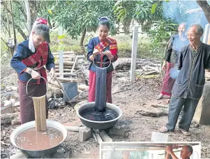  ??  ??      Villagers demonstrat­e how cotton yarn is dyed naturally. After dying, the yarn is soaked in fermented mud. The longer it remains in the mud, the softer it gets. The process also helps strengthen the yarn.