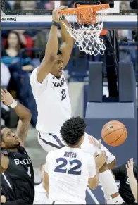  ?? AP/JOHN MINCHILLO ?? Xavier’s James Farr (2) dunks for two of his 13 points in the No. 6 Musketeers’ 88-69 victory over No. 9 Butler on Saturday in Cincinnati. Xavier was coming off a loss at No. 16 Villanova Thursday.