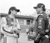  ?? CARLOS OSORIO/ASSOCIATED PRESS ?? Ryan Blaney, left, talks with Kurt Busch before a practice session Saturday for today’s race in Brooklyn, Mich.