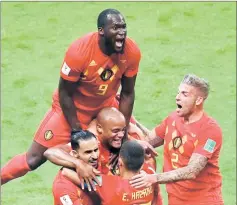  ?? — AFP photo ?? Belgium’s Romelu Lukaku jumps over teammates to celebrate Brazil’s own goal.