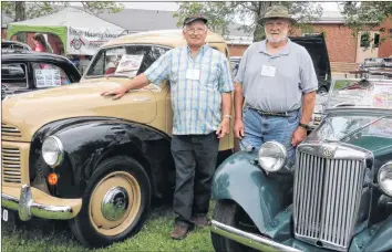  ?? CAROLE MORRIS-UNDERHILL ?? Derek Wood, of Centrevill­e, stands beside his friend, Bill Rupka, of Scott’s Bay. The pair drove their vintage vehicles to the British Motoring Festival July 14. Pictured are Wood’s 1951 Austin A40 pickup and Rupka’s 1952 MG TD.