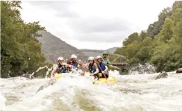  ?? West Virginia Tourism Office ?? ■ Rafters ride the rapids on the New River, which, despite its name, is considered by geologists to be one of the oldest rivers in the world.