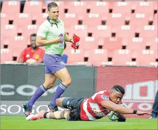  ?? Picture: AFP ?? CATALYST FOR VICTORY: The Lions’ Aphiwe Dyantyi scores a try during their Super Rugby match against the Jaguares at Ellis Park on Saturday. The Lions won 47-27