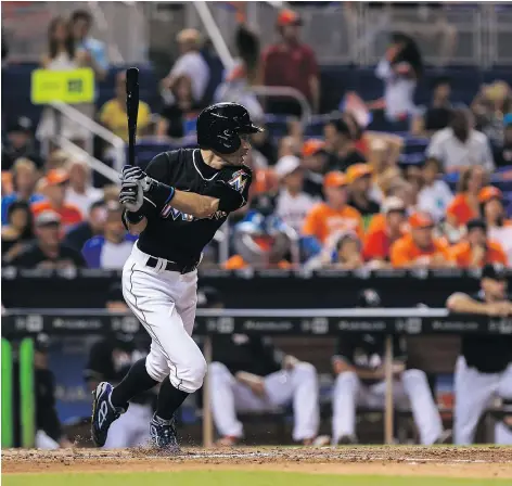  ?? — GETTY IMAGES FILES ?? Miami Marlins batter Ichiro Suzuki follows through on his 2,997th career hit during the eighth inning of a game against the Philadelph­ia Phillies at Marlins Park Tuesday night in Miami.