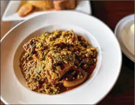  ?? WENDELL BROCK FOR THE AJC ?? The Island Grill in Duluth serves Nigerian classics, like this deeply flavorful okra stew with pounded yam.