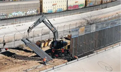  ?? AP PHOTO/ERIC GAY ?? Workers place sections of metal wall as a new barrier is built along the Texas-Mexico border near downtown El Paso in January. Such barriers have been a part of El Paso for decades and are currently being expanded, even as the fight over President Donald Trump’s desire to wall off the entire U.S.-Mexico border. Trump is expected to visit El Paso on Monday night for a rally.