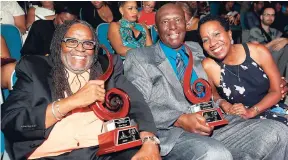  ?? PHOTO BY JANET SILVERA ?? Jackie Jackson (centre) enjoys the moment with his wife, Karen Smith (right), and fellow awardee Dean Fraser.