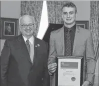  ?? PHOTO SUBMITTED/ANITA WHITTLE ?? Lieutenant Governor of Nova Scotia Arthur J. LeBlanc, left, presents the M.G. Griffiths Award to Garrett Whittle during the Lifesaving Society of Nova Scotia’s commonweal­th awards ceremony on March 29 in Halifax. Whittle, a North Sydney native, was...