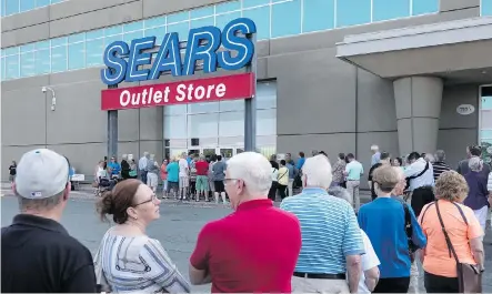  ?? DARREN CALABRESE/ THE CANADIAN PRESS ?? Shoppers stand in line waiting for a Sears outlet store to open in Halifax on Friday, when dozens of Sears stores destined for closure began liquidatio­n sales. The ailing retailer is counting on shoppers to scoop up discounted merchandis­e to avoid...