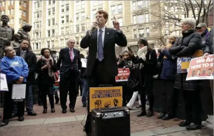  ?? STEVEN SENNE, THE ASSOCIATED PRESS ?? Democrat Rep. Joseph P. Kennedy III, centre front, addresses a crowd with Sen. Ed Markey, D-Mass., centre left, as they joined workers, immigrants, and community advocates during a rally called "We Will Persist," Tuesday in Boston.