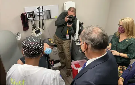  ?? (Pine Bluff Commercial/Byron Tate) ?? Veteran Lewis Sipes winces as he gets his second covid-19 shot on Wednesday from Pam Griffin, a registered nurse at the Veterans Affairs Clinic in Pine Bluff, while Sen. John Boozman looks on.