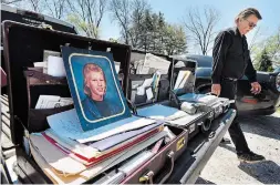  ?? JOHN RENNISON THE HAMILTON SPECTATOR ?? Don Armstrong walks past three brief cases of informatio­n on Troy’s case on the tailgate of his pickup. It represents just some of the material he has collected in his investigat­ion that spans 22 years.
