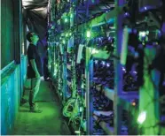  ?? PROVIDED TO CHINA DAILY ?? A technician checks mining equipment at a bitcoin mine in Sichuan province.