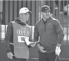  ?? IAN RUTHERFORD/USA TODAY SPORTS ?? Brooks Koepka, with caddie Ricky Elliott, shot 68 in Thursday’s first round of the British Open.