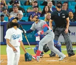  ?? MARK J. TERRILL/AP ?? Seiya Suzuki heads to first after hitting a solo home run as Dodgers pitcher Andre Jackson and home plate umpire Jim Wolf watch during the eighth inning Friday.