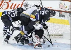  ?? John Woods ?? The Canadian Press Knights goaltender Marc-andre Fleury stops the puck — and Winnipeg’s Blake Wheeler and teammate Colin Miller — in overtime Thursday.