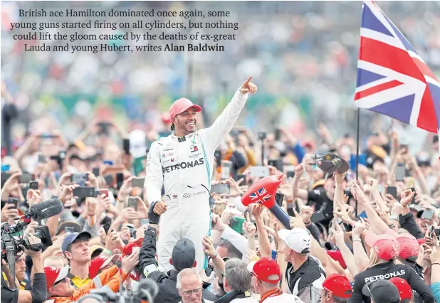  ?? REUTERS ?? ABOVE
Mercedes’ Lewis Hamilton celebrates with the crowd after winning the British Grand Prix at Silverston­e.