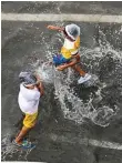  ?? Virendra Saklani/Gulf News ?? ■ Below: Children play on a flooded street in Sharjah’s Al Majaz area.