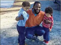  ?? COURTESY MICHAEL HARPER ?? In 2015, Antonio May poses with sons Za’kobe and Jordan Rickerson. May died in 2018 in Fulton County jail; his family’s wrongful death suit says he was tased, beaten.