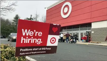  ?? TED SHAFFREY — THE ASSOCIATED PRESS ?? A hiring sign is in front of a Target store in Manchester, Conn. Workers at Target stores and distributi­on centers in places like New York, where competitio­n for finding and hiring staff is the fiercest, could see starting wages as high as $24an hour this year.