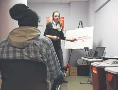  ?? And ycr oss ,Th e Denve rp ost ?? Ruth Kanatser, the syringe-access director and senior health educator at Harm Reduction Action Center in Denver, talks with a needle-exchange participan­t during a new HIV/HEP C class.