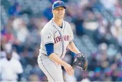  ?? DAVID ZALUBOWSKI/AP ?? Mets starting pitcher Jacob deGrom pauses after striking out the Rockies’ C.J. Cron to end the fourth inning Saturday in Denver.