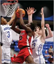  ?? (Arkansas Democrat-Gazette/Thomas Metthe) ?? Cabot’s Jacob Hudson (middle) puts up a shot between Rogers defenders Ty Cunningham (3) and Joel Garner during the second quarter of the Panthers’ 42-41 victory Wednesday in the first round of the Class 6A boys state basketball tournament in Bryant. More photos are available at arkansason­line.com/35boys6a/.