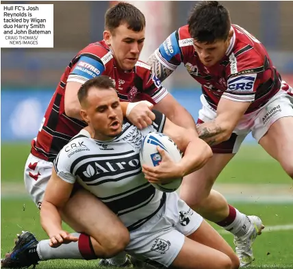  ?? CRAIG THOMAS/ NEWS IMAGES ?? Hull FC’S Josh Reynolds is tackled by Wigan duo Harry Smith and John Bateman
